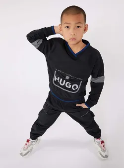 HUGO pantaloni copii culoarea albastru marin, neted